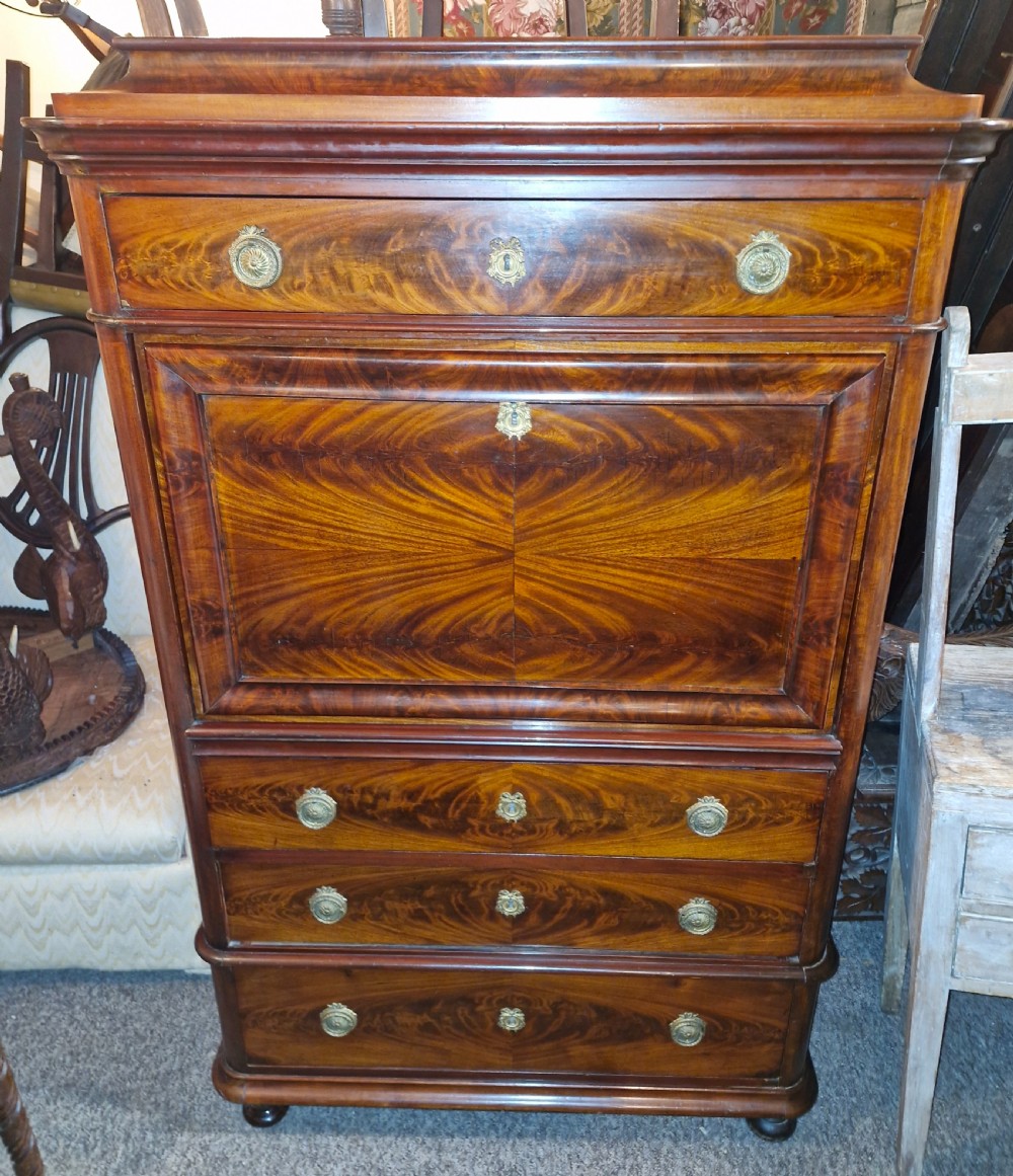 A 19th-century mahogany fall-front escritoire featuring flame mahogany veneer panels, a drop-down writing surface, multiple storage drawers, and brass fittings. View XII