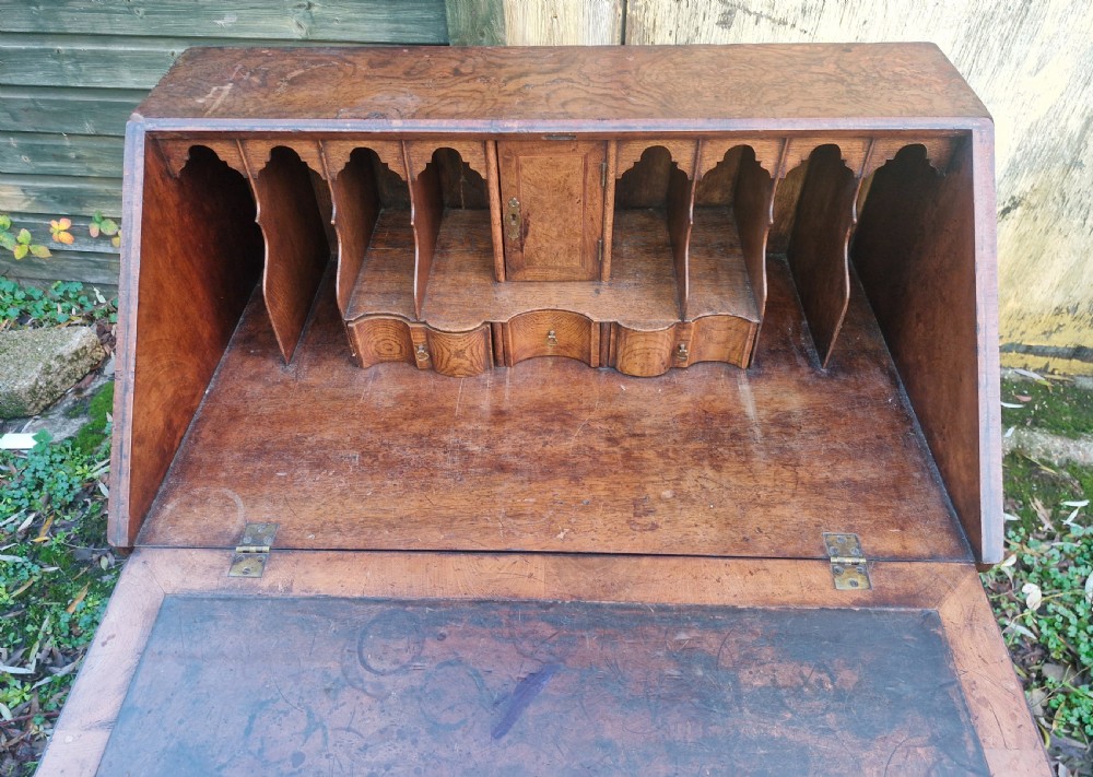 A Queen Anne style burr walnut and burr elm slant-front writing bureau raised on turned legs with a stretcher base. View II