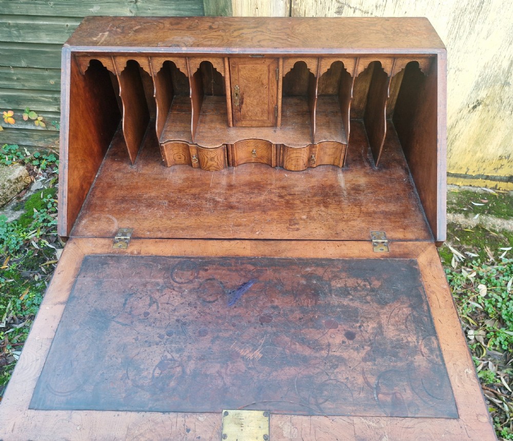 A Queen Anne style burr walnut and burr elm slant-front writing bureau raised on turned legs with a stretcher base. View III
