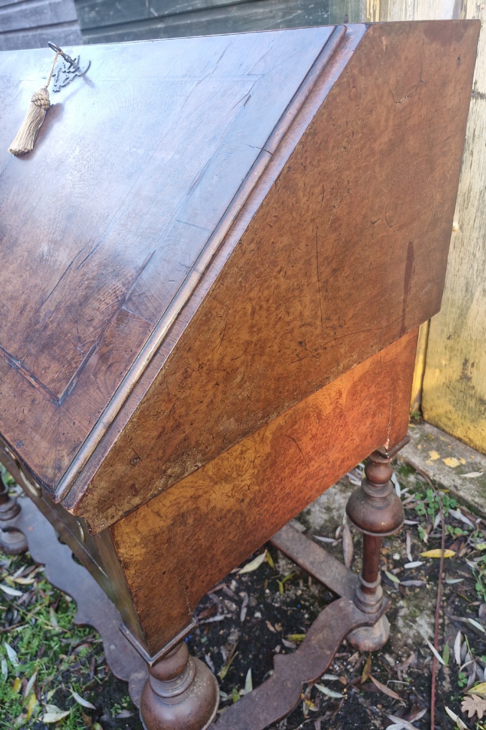 A Queen Anne style burr walnut and burr elm slant-front writing bureau raised on turned legs with a stretcher base. View V
