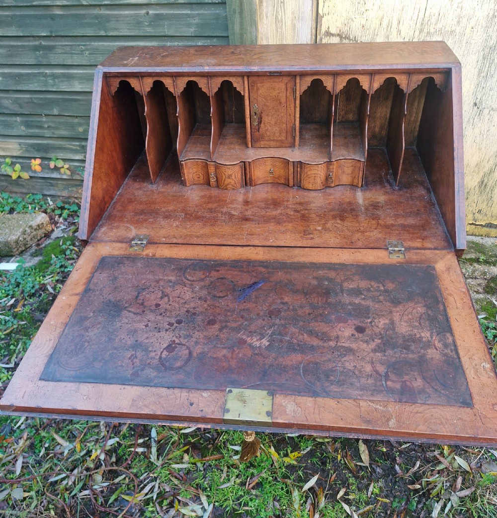 A Queen Anne style burr walnut and burr elm slant-front writing bureau raised on turned legs with a stretcher base. View VI