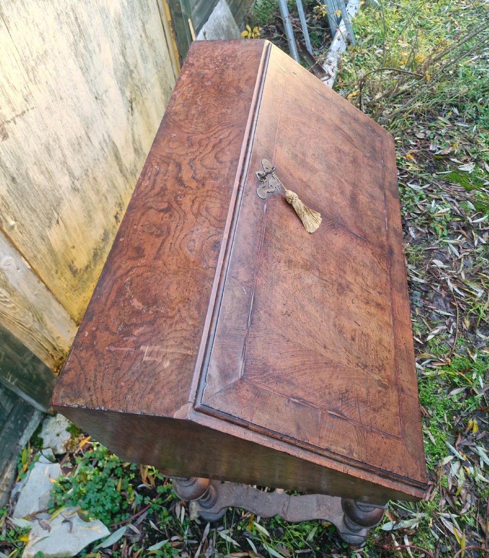 A Queen Anne style burr walnut and burr elm slant-front writing bureau raised on turned legs with a stretcher base. View VIII