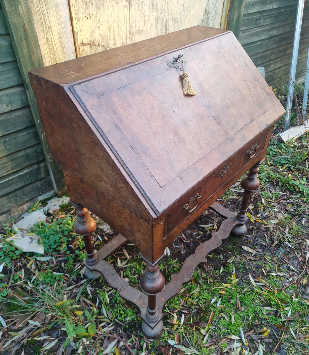 A Queen Anne style burr walnut and burr elm slant-front writing bureau raised on turned legs with a stretcher base. View XI