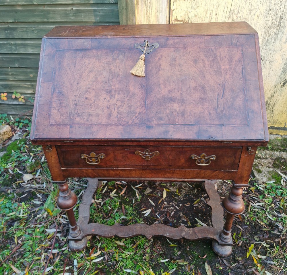 A Queen Anne style burr walnut and burr elm slant-front writing bureau raised on turned legs with a stretcher base. View XII