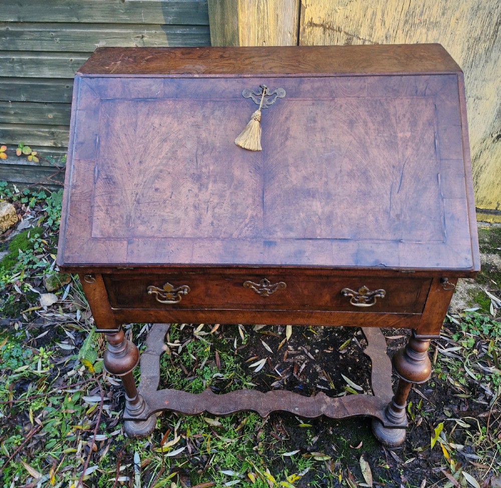 A Queen Anne style burr walnut and burr elm slant-front writing bureau raised on turned legs with a stretcher base. View XIII