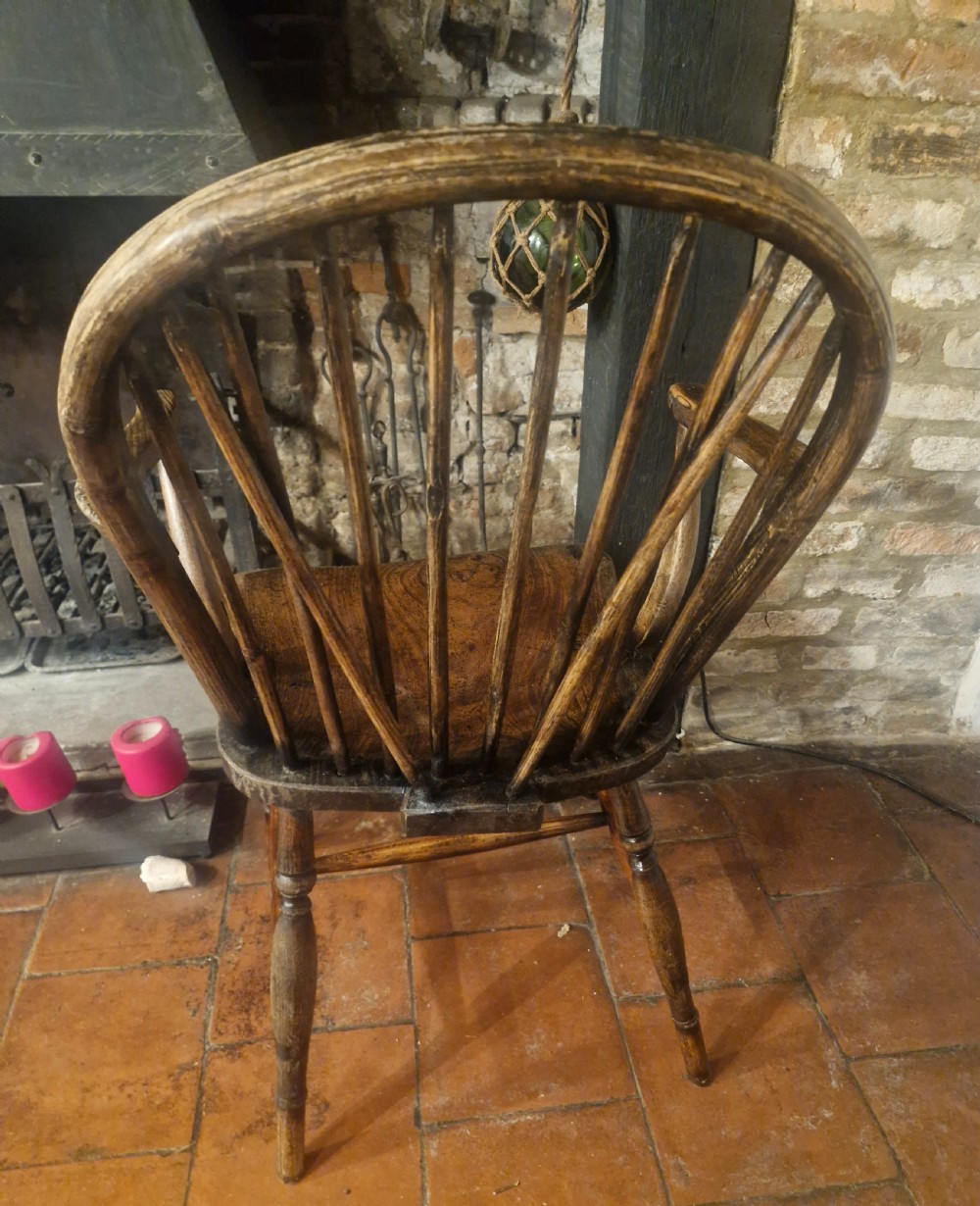 A 19th-century dark wooden Windsor armchair featuring a curved stick back, sculpted seat, curved armrests, and turned legs. View IV