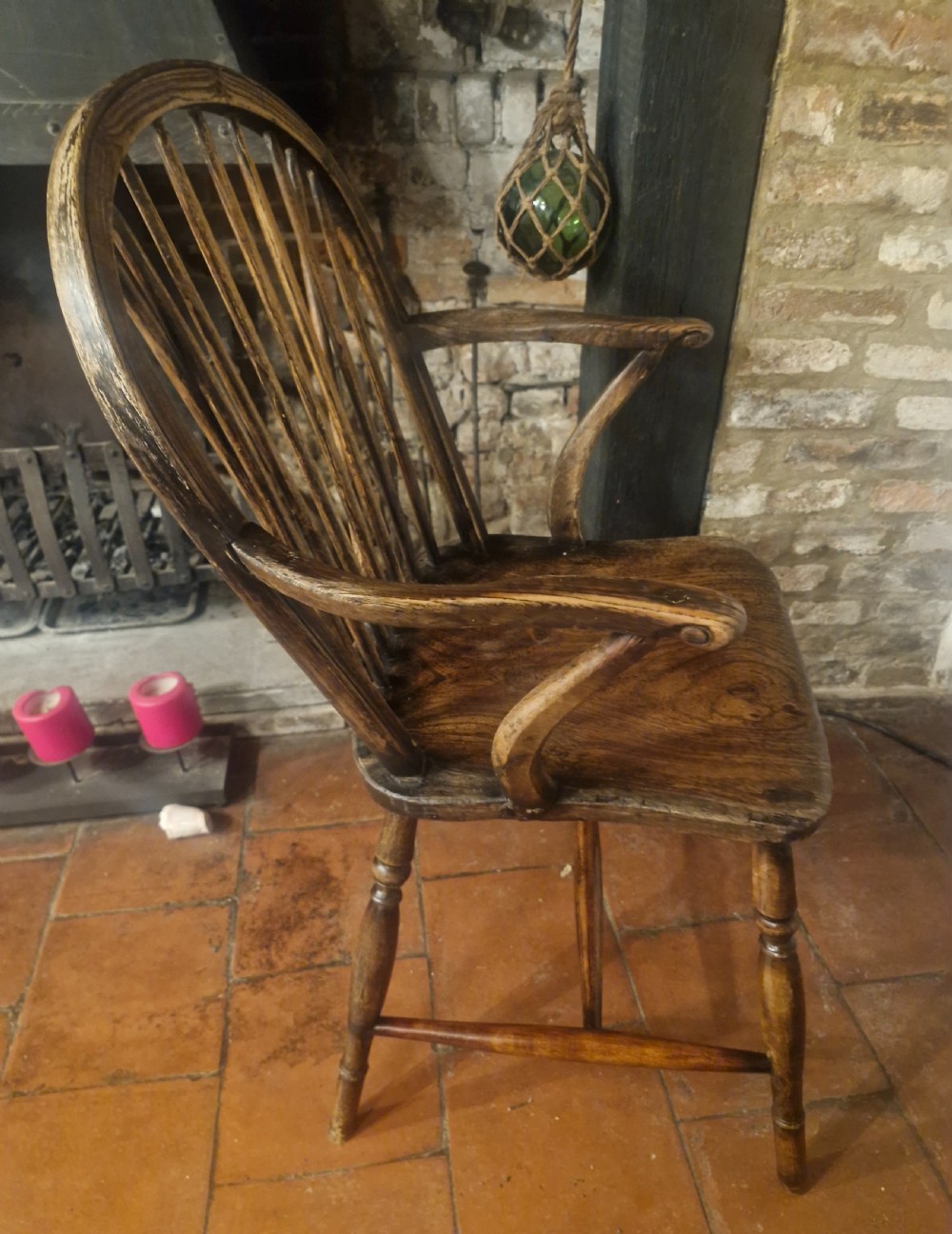 A 19th-century dark wooden Windsor armchair featuring a curved stick back, sculpted seat, curved armrests, and turned legs. View V
