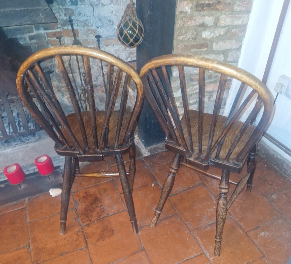 A pair of Victorian stick back Windsor kitchen chairs crafted from timber with contoured seats and turned front legs. View II