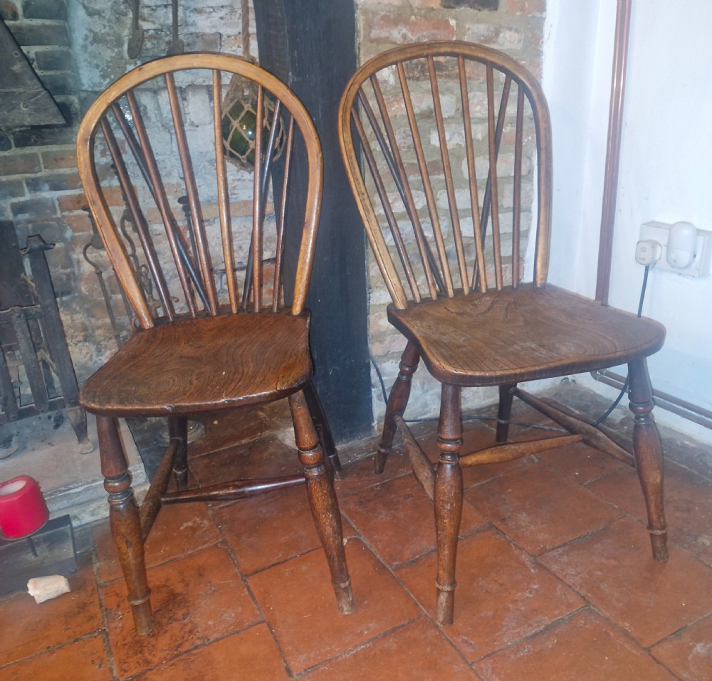A pair of Victorian stick back Windsor kitchen chairs crafted from timber with contoured seats and turned front legs. View III