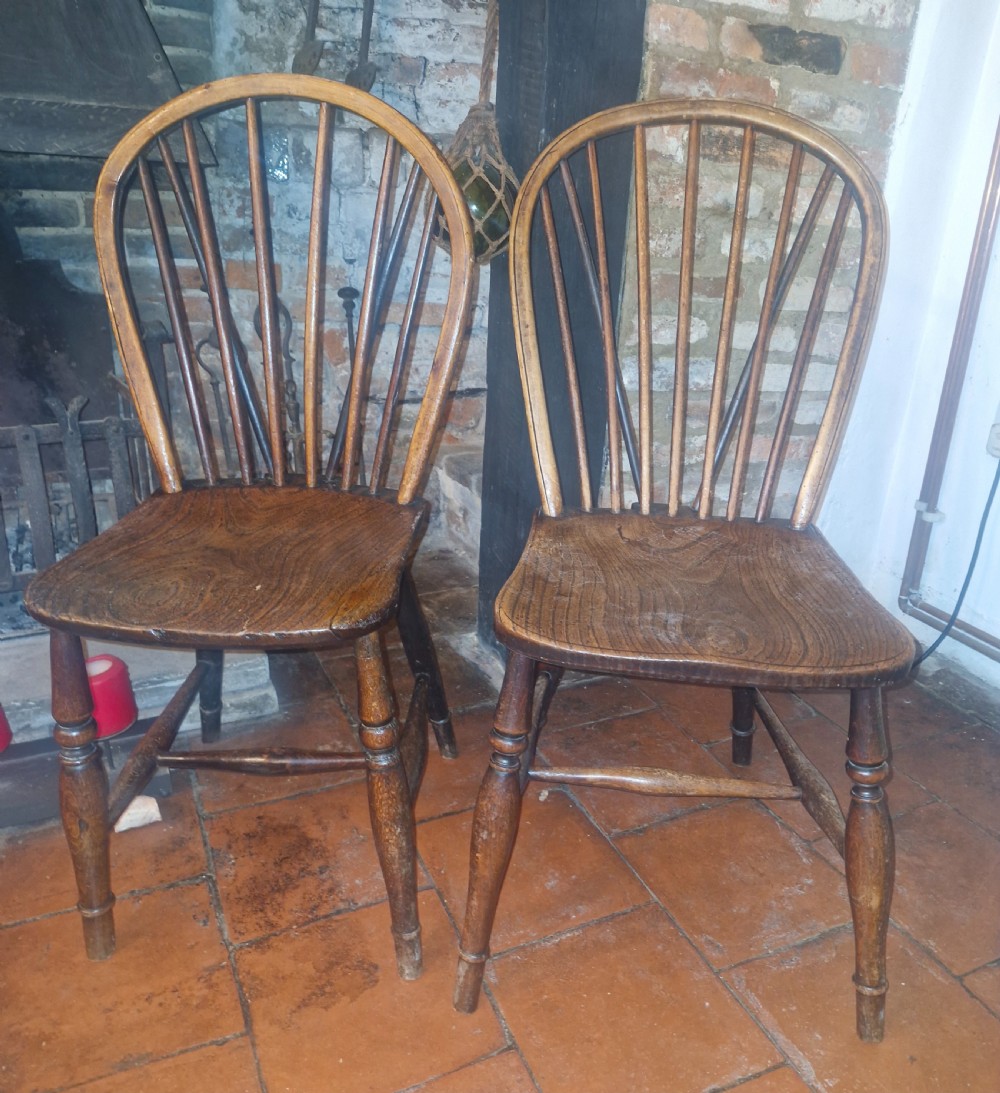 A pair of Victorian stick back Windsor kitchen chairs crafted from timber with contoured seats and turned front legs. View V