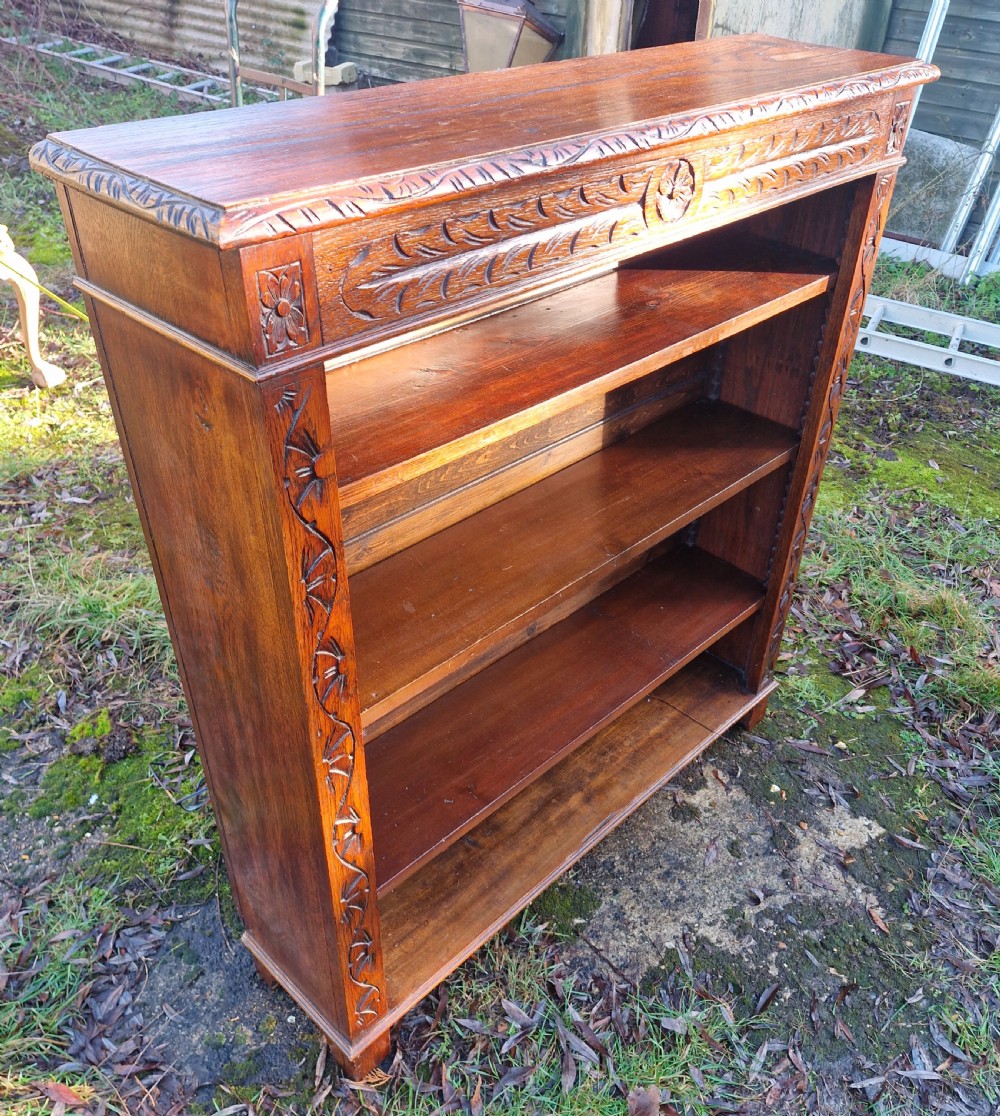 Edwardian carved oak open front bookcase. 