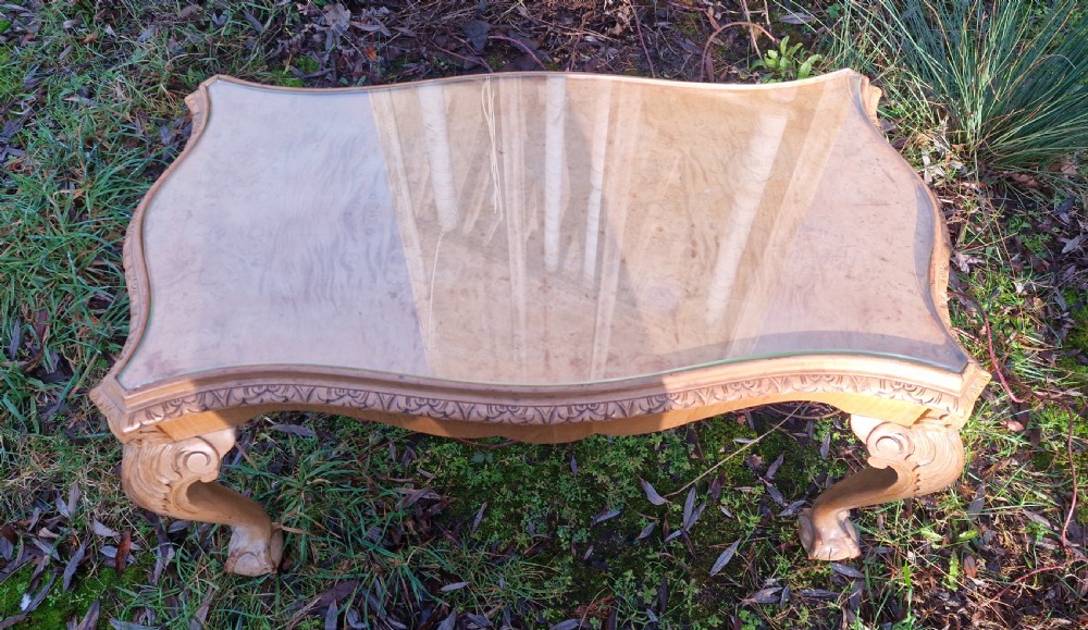 A low rectangular bleached walnut coffee table featuring a glass top insert, carved apron detailing, and cabriole legs. View IV