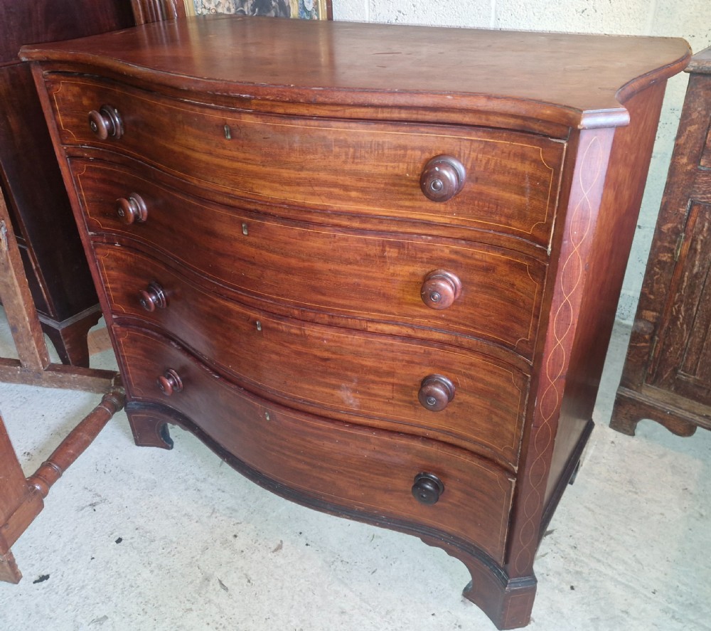 Early 19th century line inlaid mahogany serpentine front chest of drawers.  View II