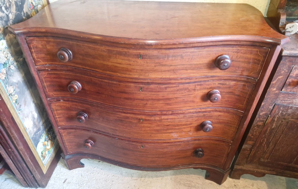 Early 19th century line inlaid mahogany serpentine front chest of drawers.  View VIII