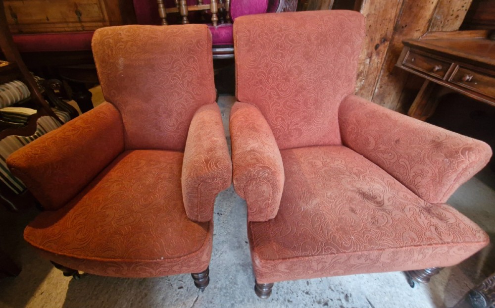 A close matched pair of upholstered armchairs. 