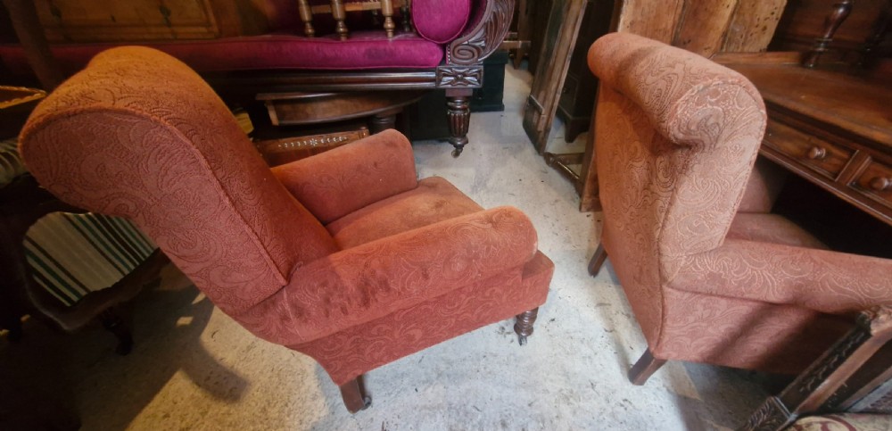 A close matched pair of upholstered armchairs.  View IV