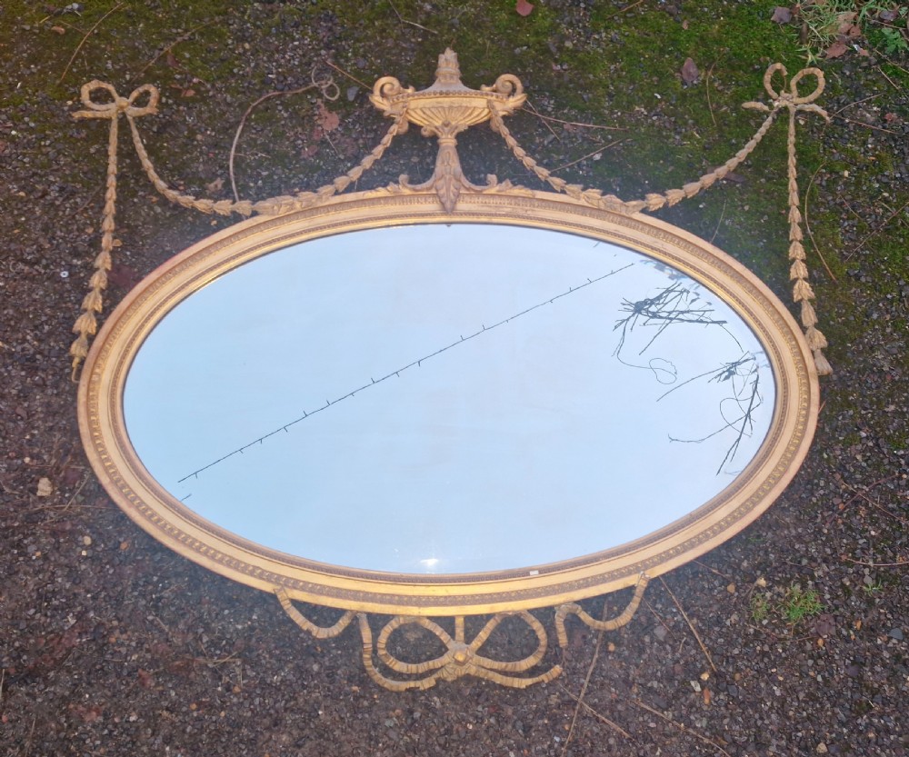 Edwardian gilt oval wall mirror. 
