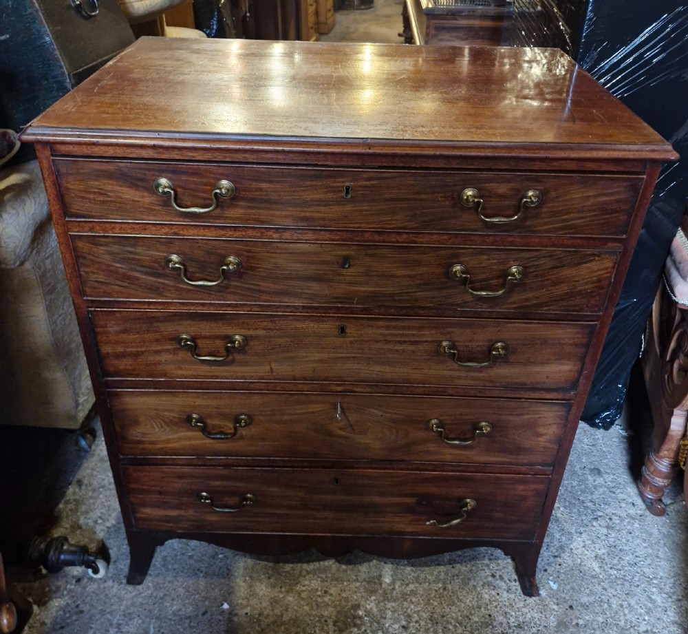 A Regency mahogany secretaire chest featuring five drawer fronts with brass swan-neck handles, keyhole escutcheons, and a shaped apron base. View II