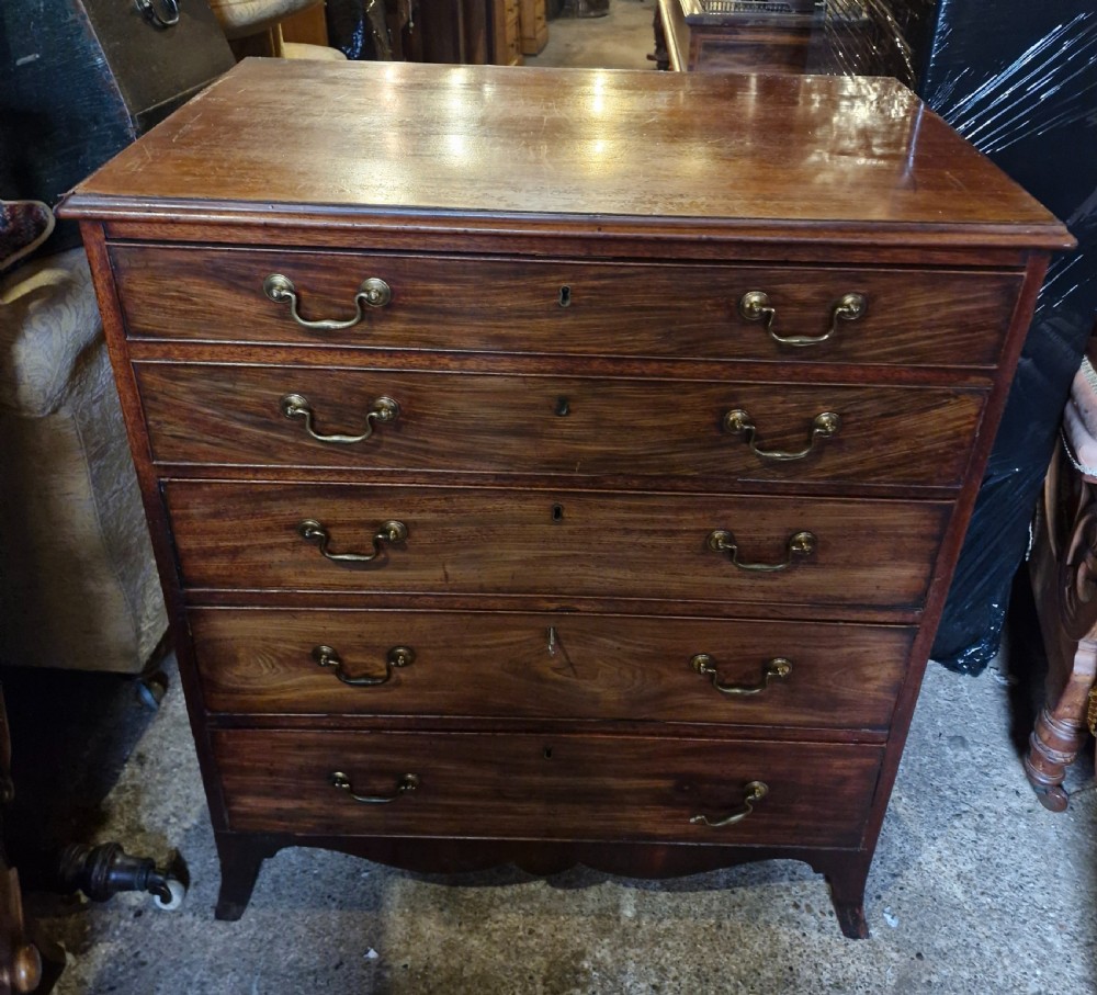 A Regency mahogany secretaire chest featuring five drawer fronts with brass swan-neck handles, keyhole escutcheons, and a shaped apron base. View III