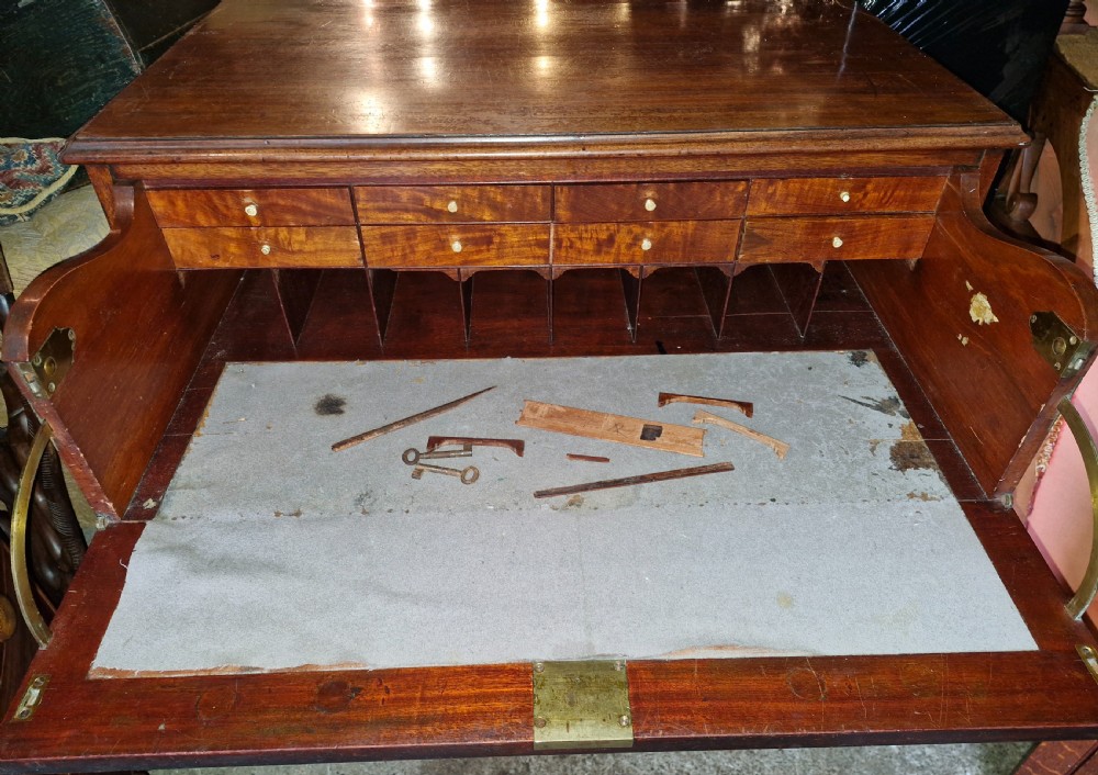 A Regency mahogany secretaire chest featuring five drawer fronts with brass swan-neck handles, keyhole escutcheons, and a shaped apron base. View VIII