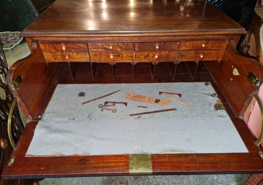 A Regency mahogany secretaire chest featuring five drawer fronts with brass swan-neck handles, keyhole escutcheons, and a shaped apron base. View IX