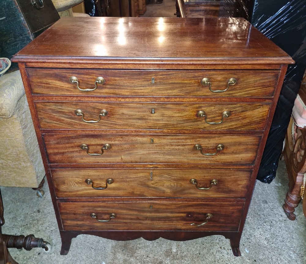 A Regency mahogany secretaire chest featuring five drawer fronts with brass swan-neck handles, keyhole escutcheons, and a shaped apron base. View XI