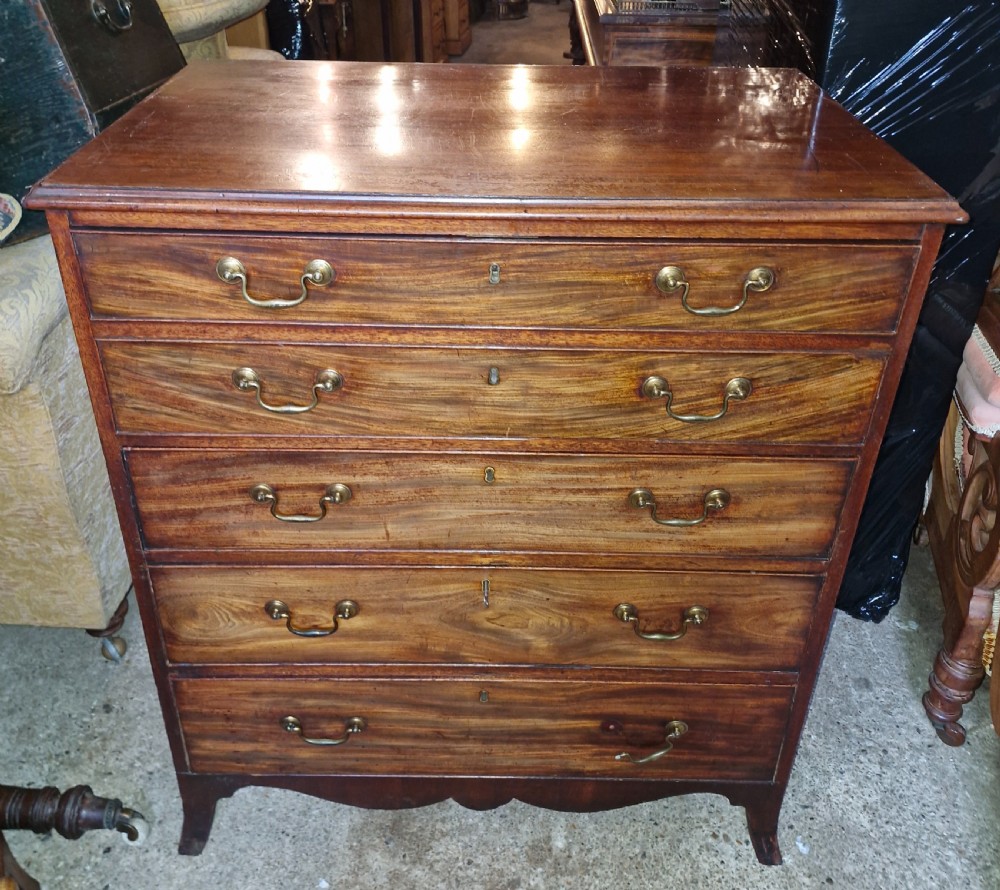 A Regency mahogany secretaire chest featuring five drawer fronts with brass swan-neck handles, keyhole escutcheons, and a shaped apron base. View XII