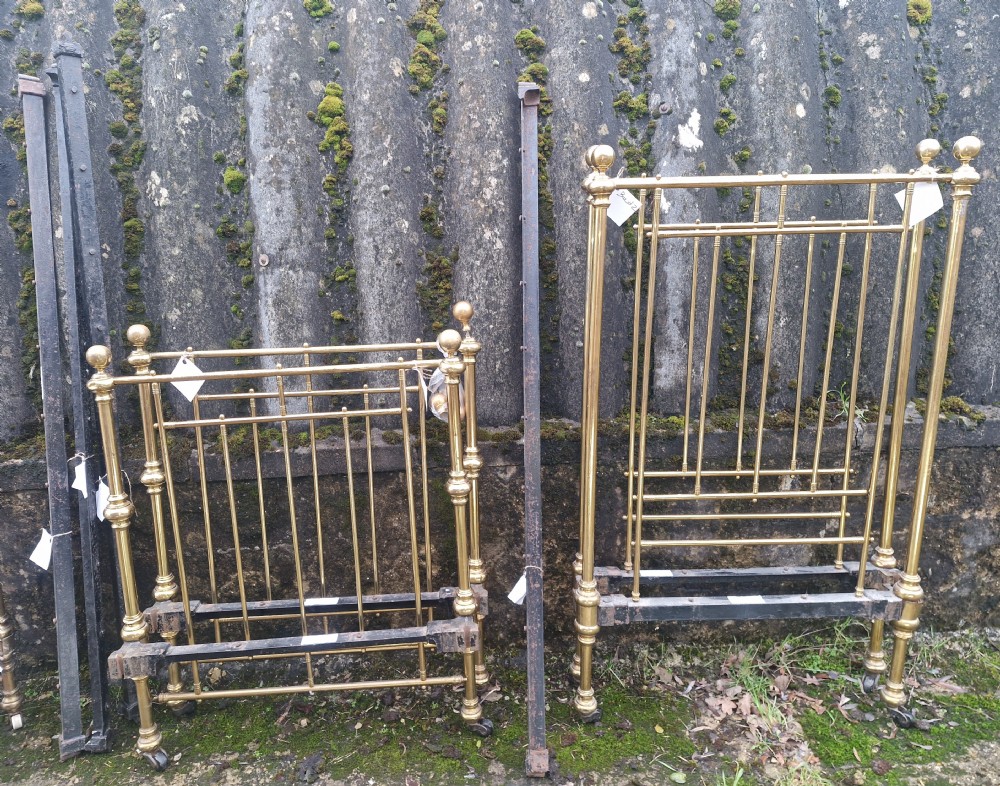 Pair of Late Victorian brass single beds with irons.