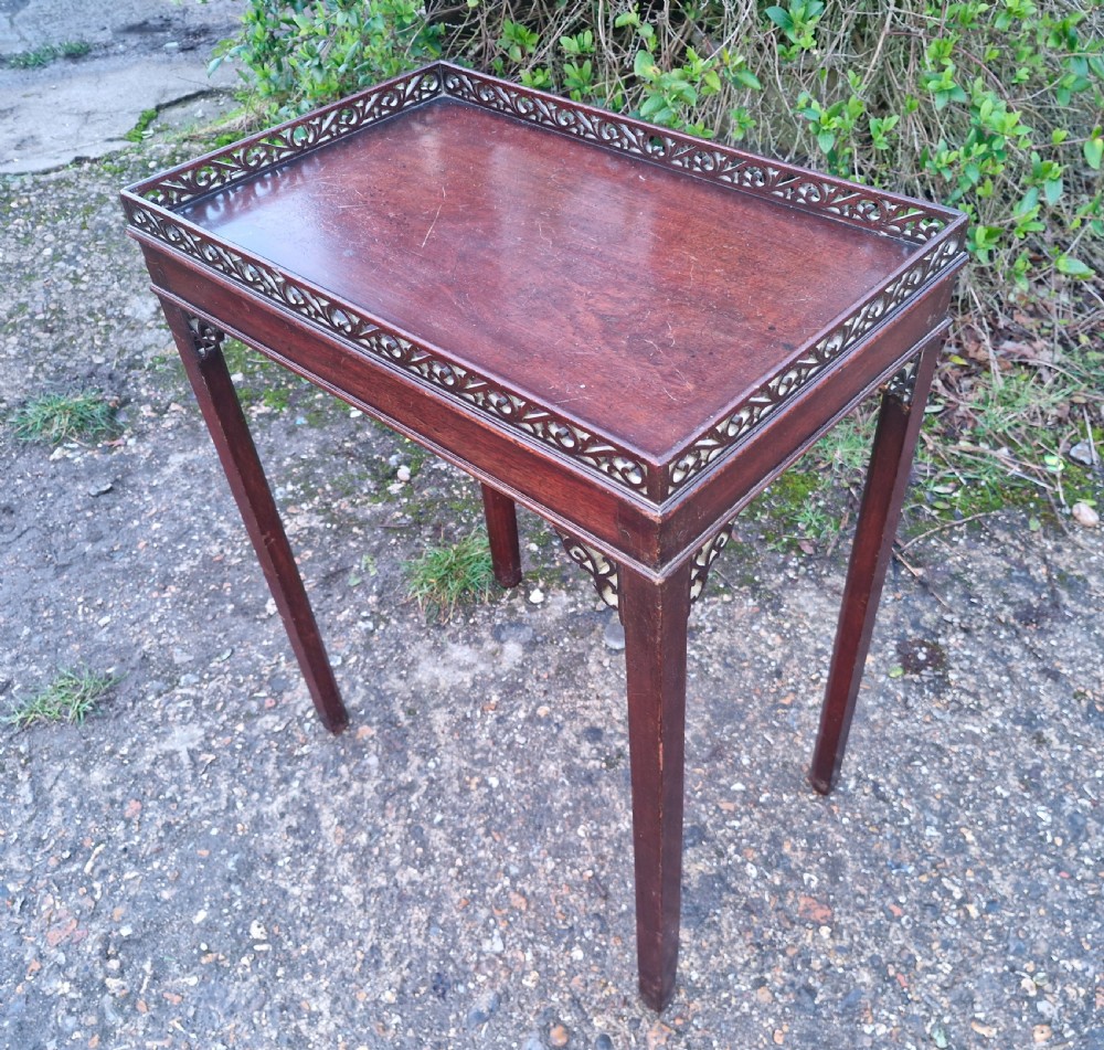 Small mahogany silver table with fret work gallery. 