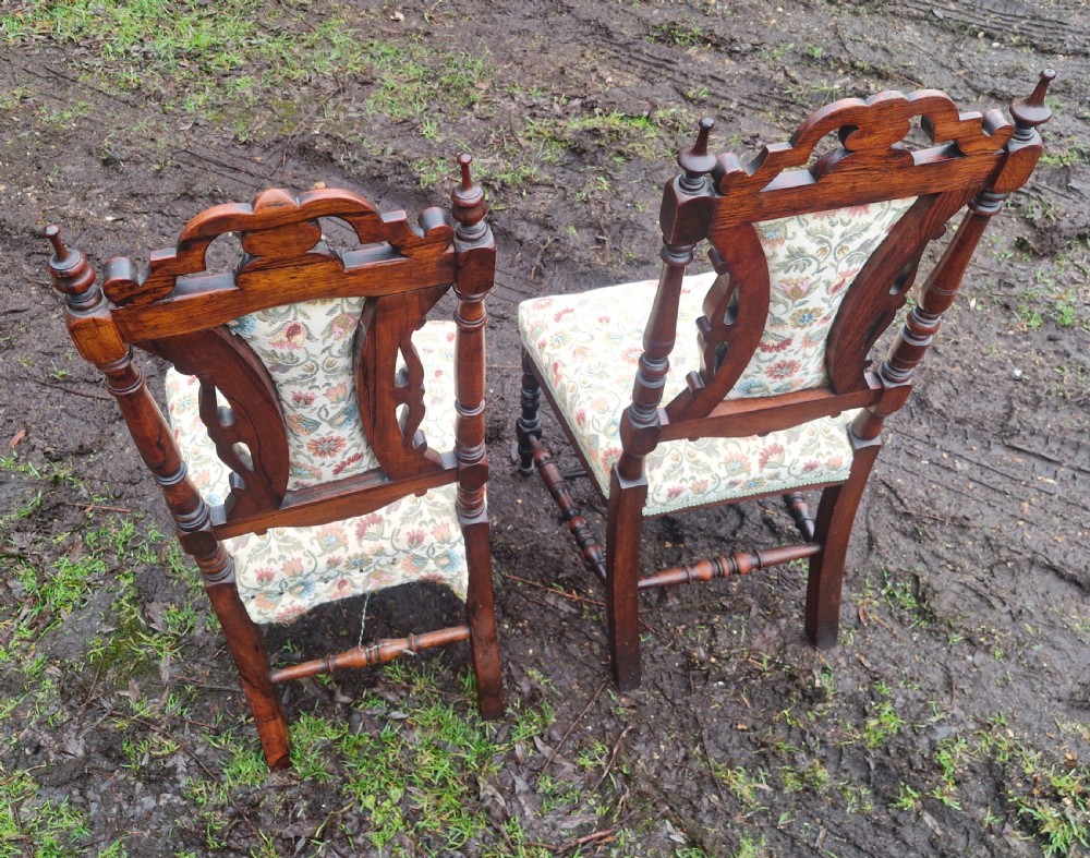 A pair of mid-19th century carved rosewood side chairs with floral tapestry upholstered seats and back pads. View II