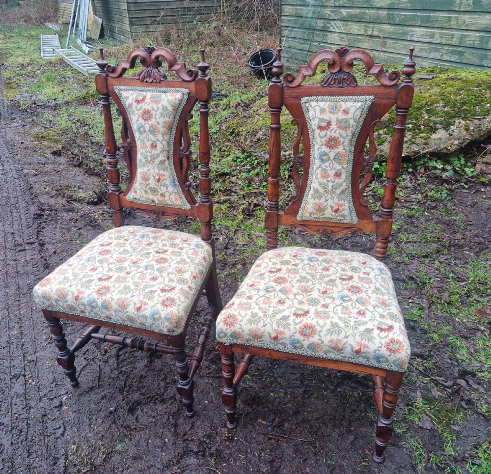 A pair of mid-19th century carved rosewood side chairs with floral tapestry upholstered seats and back pads. View IV