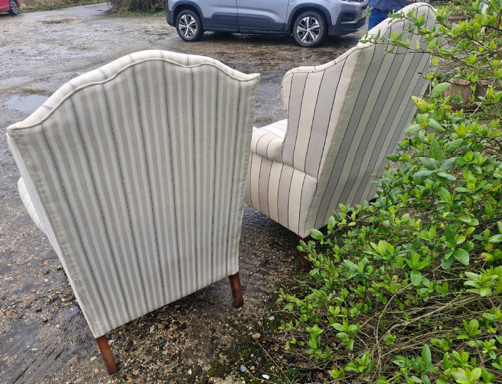 A pair of high-backed upholstered wingback armchairs featuring striped beige fabric and carved wooden cabriole legs with ball and claw feet. View IV