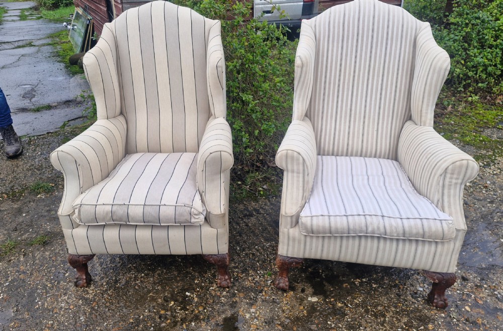 A pair of high-backed upholstered wingback armchairs featuring striped beige fabric and carved wooden cabriole legs with ball and claw feet. View VII