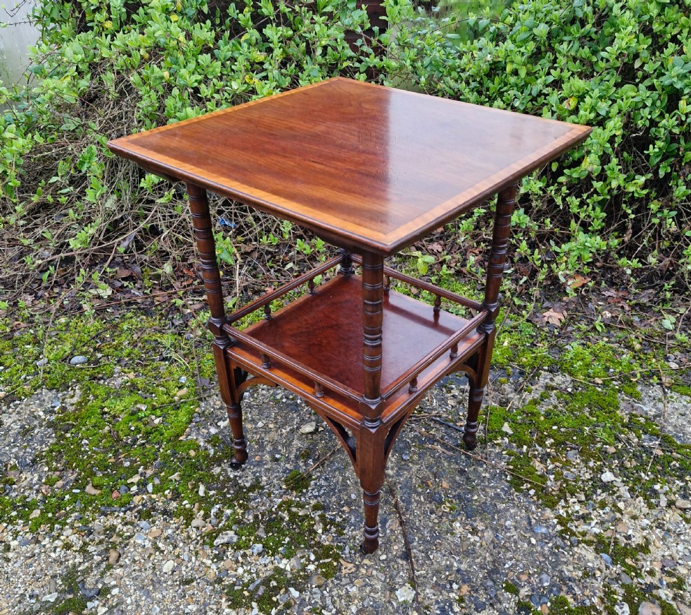 Inlaid mahogany occasional table in the style of Godwin. 