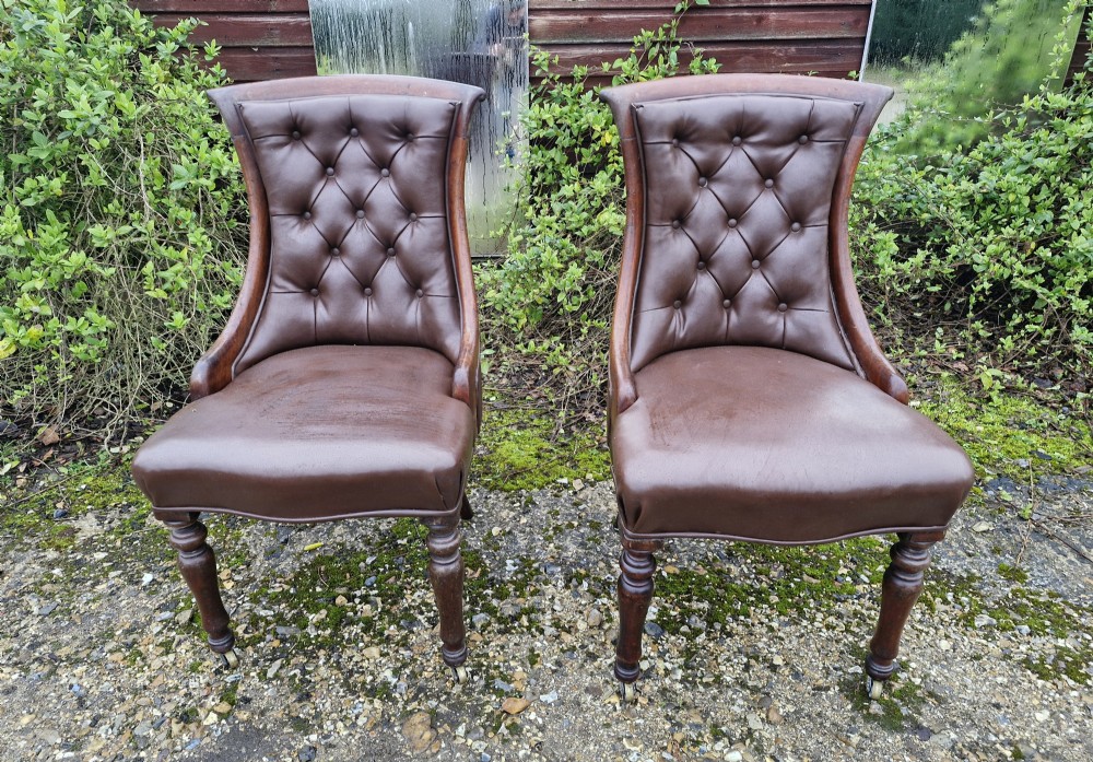 Pair of Regency mahogany upholstered hall chairs. Stamped castors. 