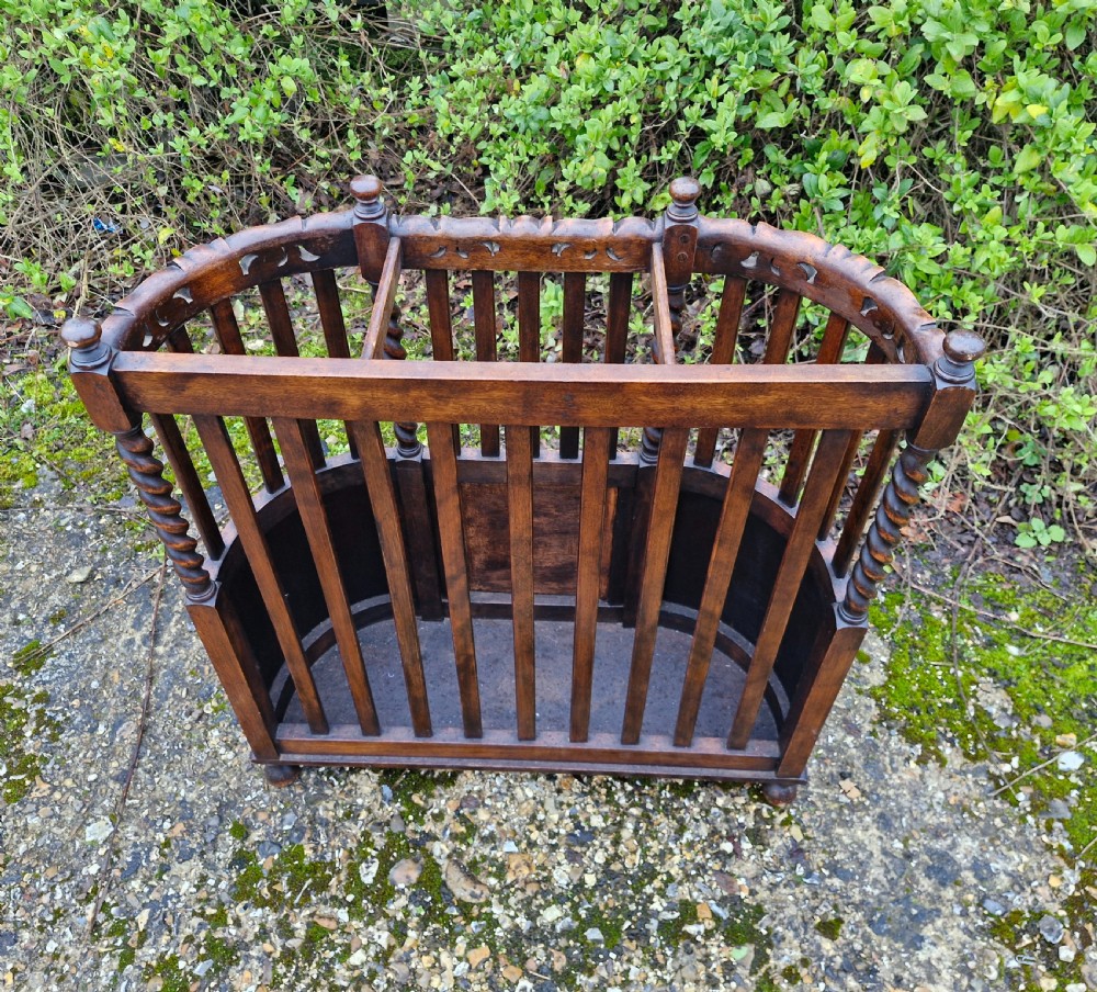 A carved dark oak stick and umbrella stand featuring barley twist supports, vertical wooden slats, and lower woven cane panels. View II