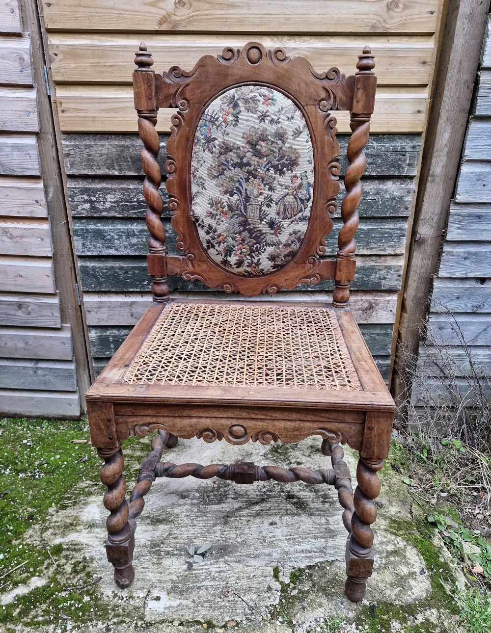 A late 19th-century carved satinwood hall chair featuring barley twist supports, a woven cane seat, and an oval tapestry back panel. View IV