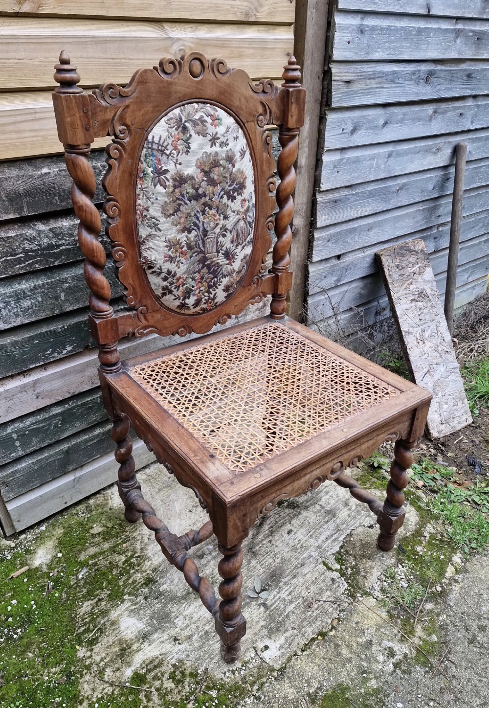 A late 19th-century carved satinwood hall chair featuring barley twist supports, a woven cane seat, and an oval tapestry back panel. View VII