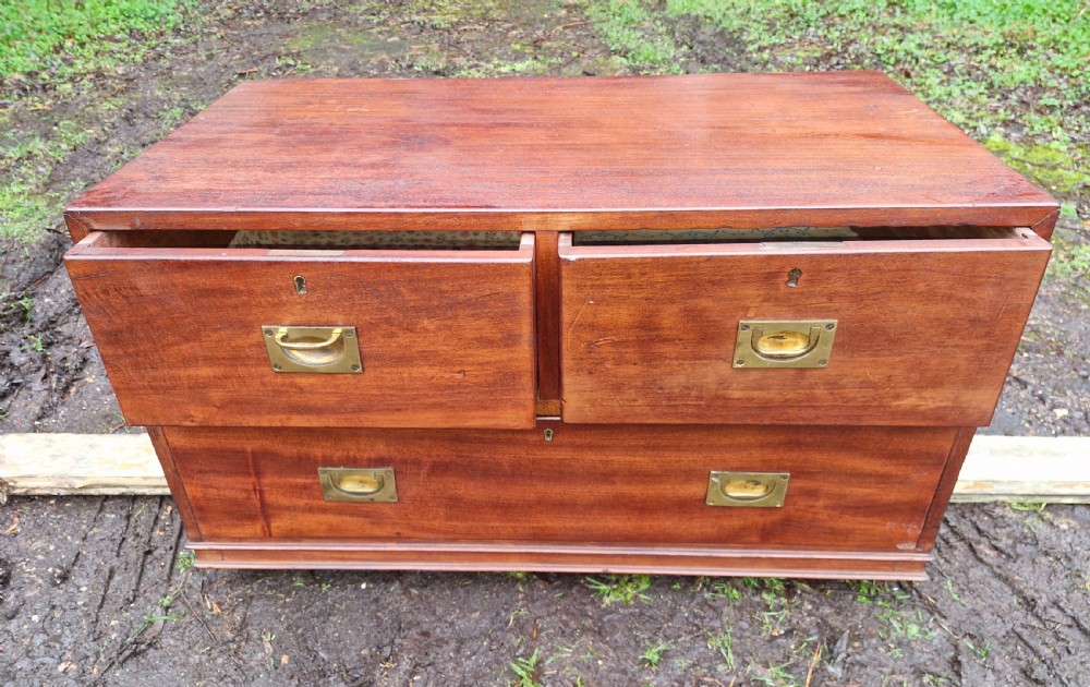 A low mahogany campaign chest of drawers with recessed brass handles and keyholes. View II