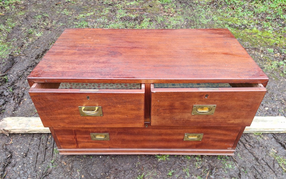 A low mahogany campaign chest of drawers with recessed brass handles and keyholes. View III