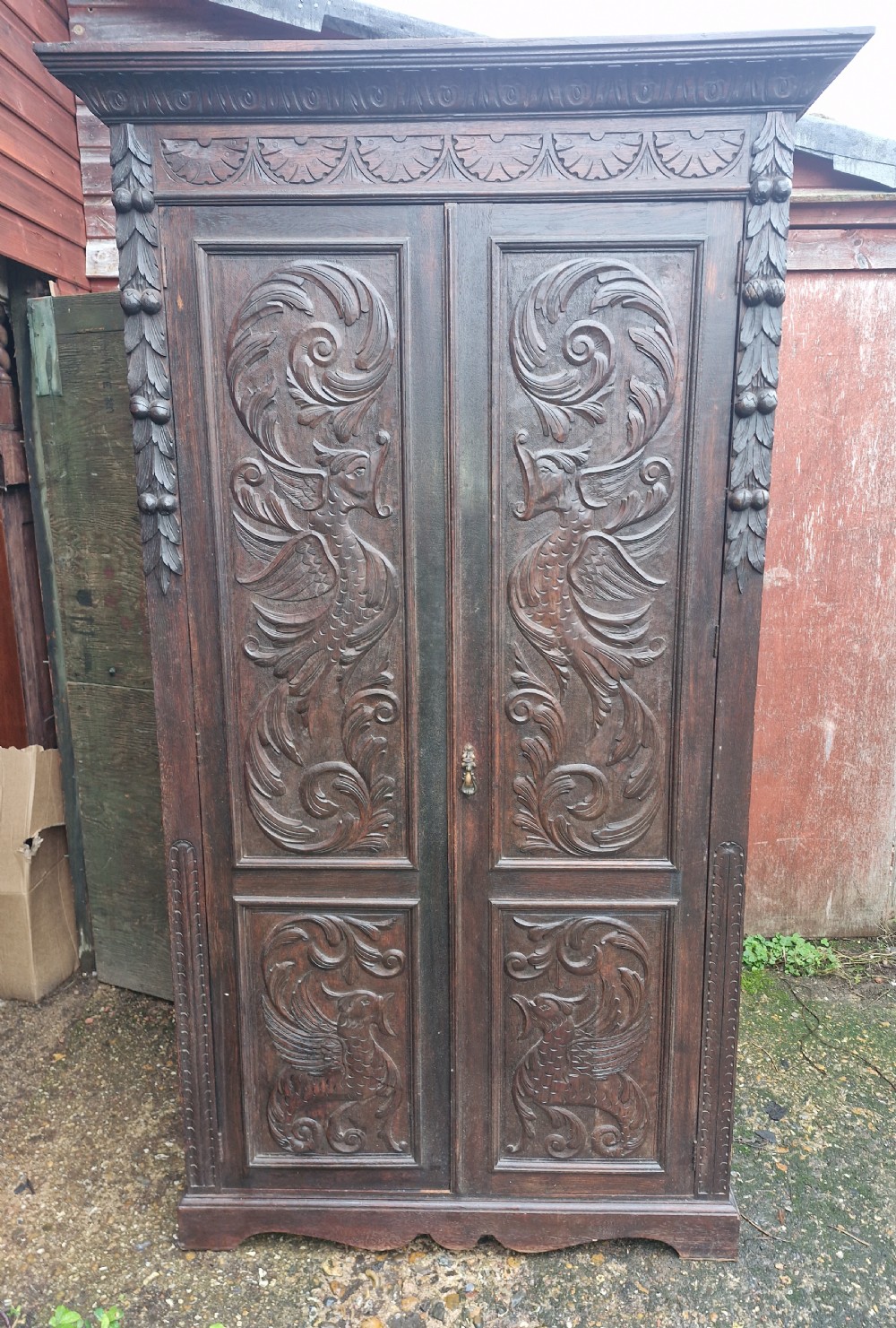 Useful late Victorian carved oak 2 door cupboard. Fitted shelves.  View II