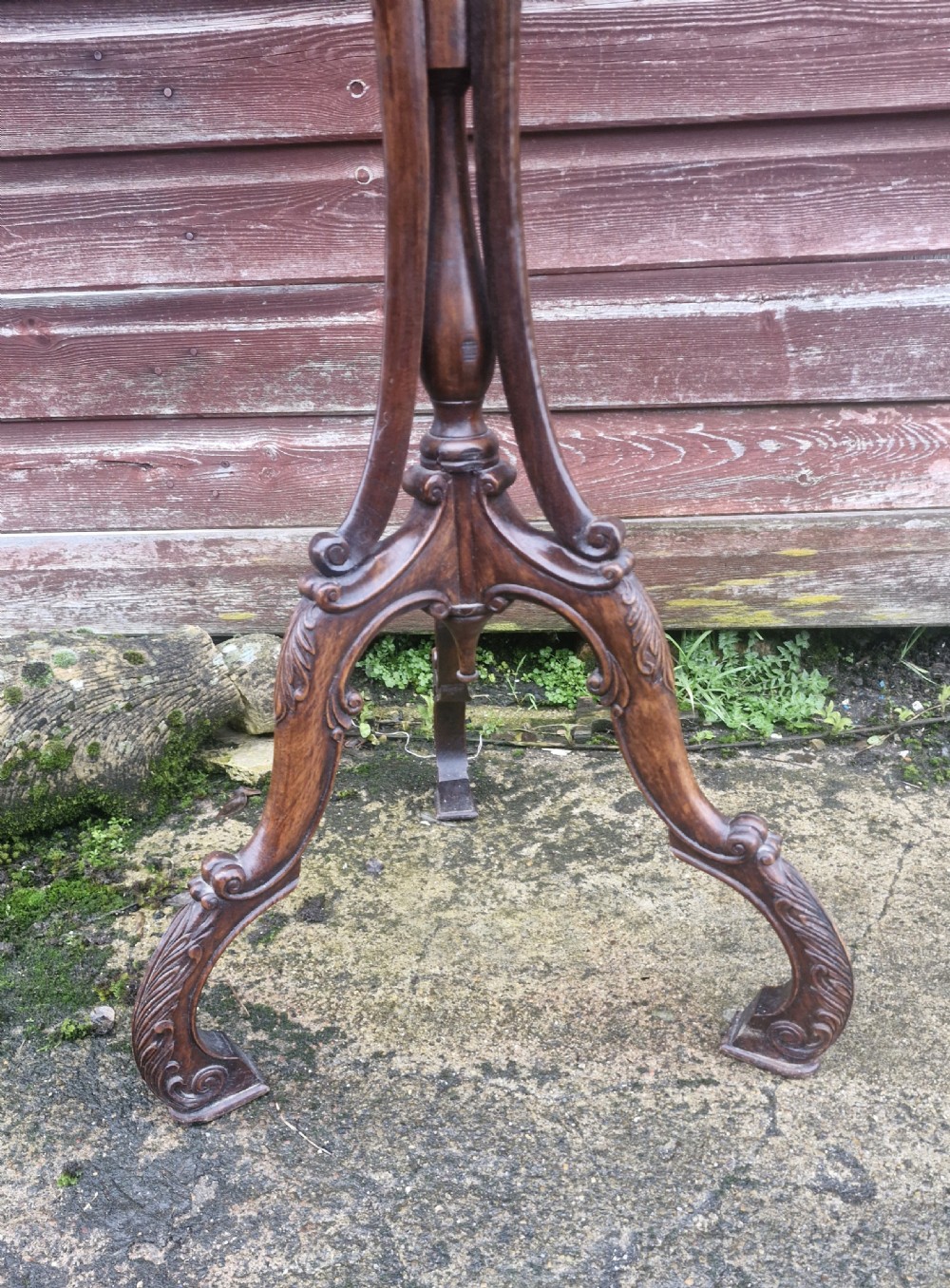 A tall dark carved wooden jardiniere stand featuring a circular top with a pierced lattice gallery supported by sweeping curved legs. View III