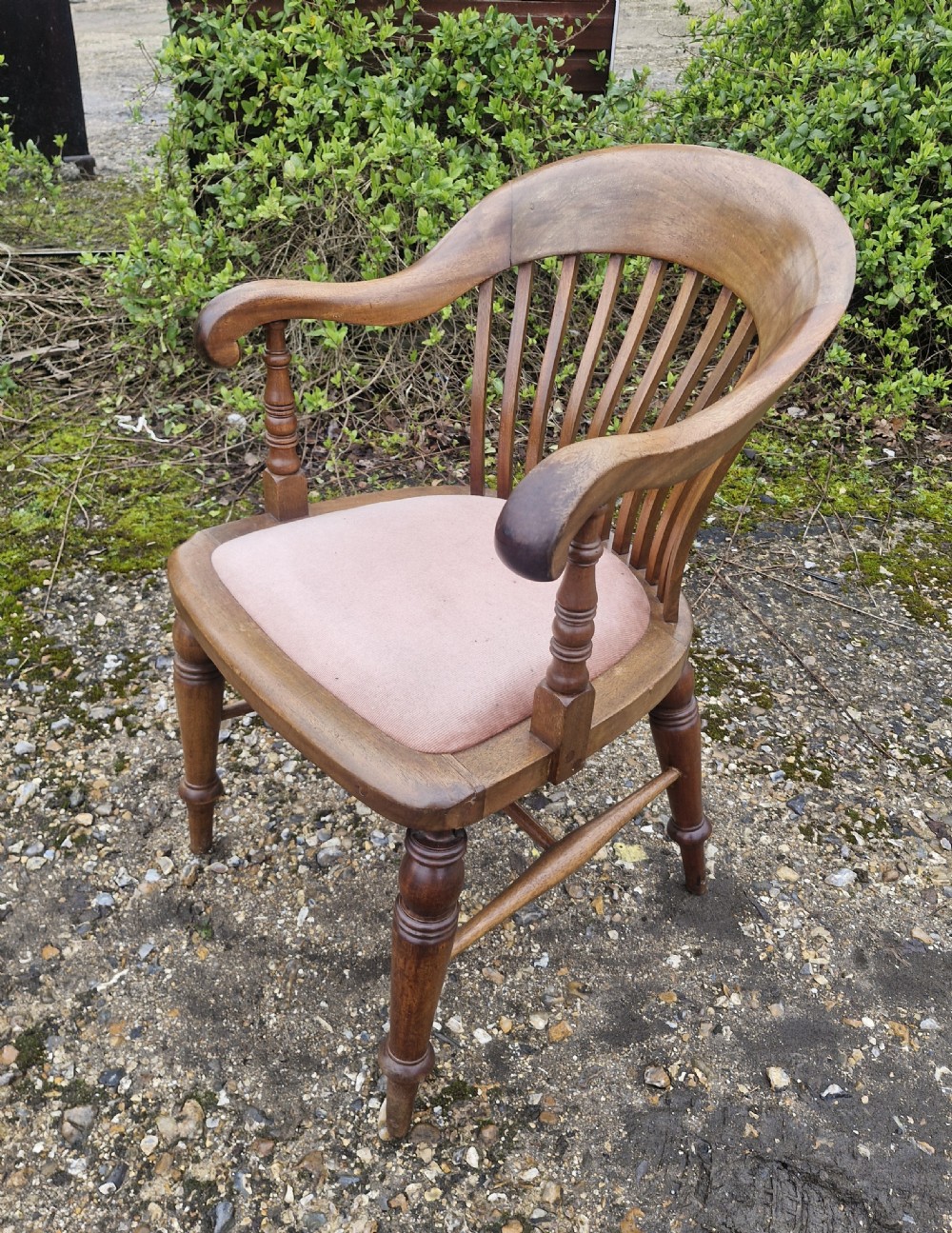 An early 20th-century mahogany military desk armchair featuring a spindle back, turned front legs, and a padded seat. View VII