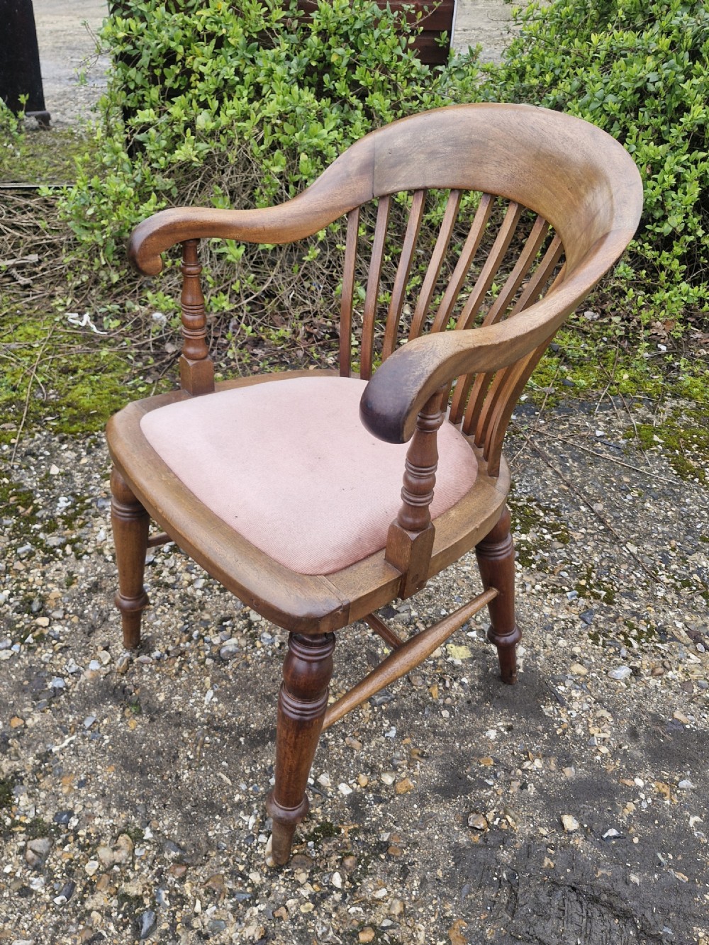 An early 20th-century mahogany military desk armchair featuring a spindle back, turned front legs, and a padded seat. View VIII