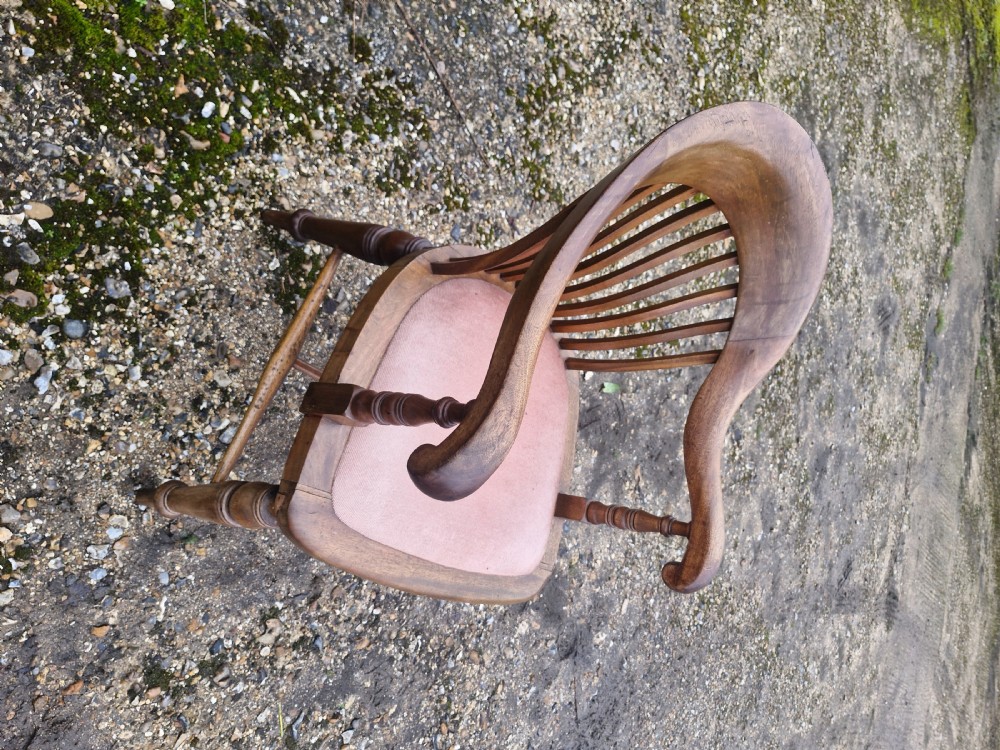 An early 20th-century mahogany military desk armchair featuring a spindle back, turned front legs, and a padded seat. View XI