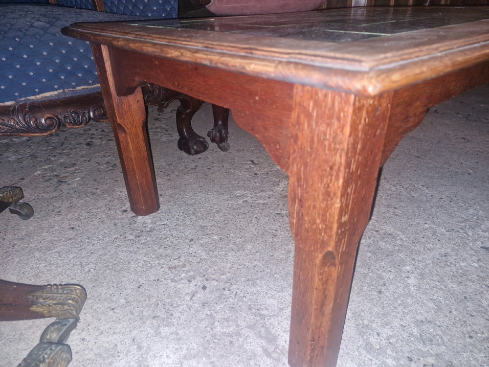A low rectangular oak coffee table featuring an inset top crafted from square dark green glazed ceramic tiles. View IV