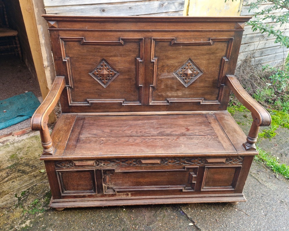 Edwardian oak hall seat with lift up seat.