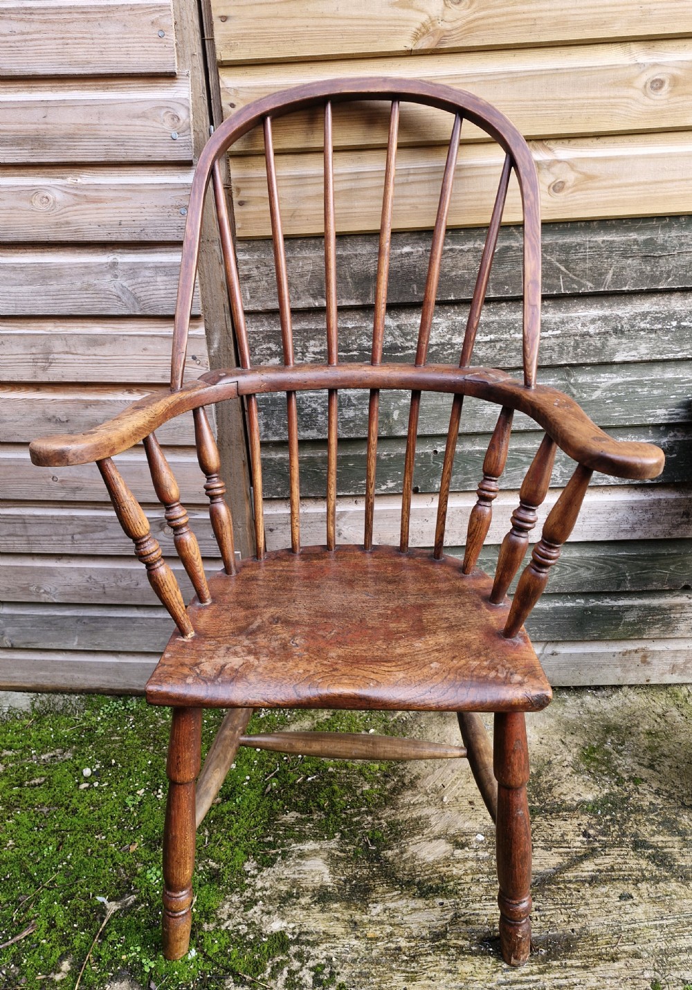 An early 19th-century West Country Windsor armchair with a high hoop back, turned wooden spindles, curved armrests, and a contoured saddle seat. View III