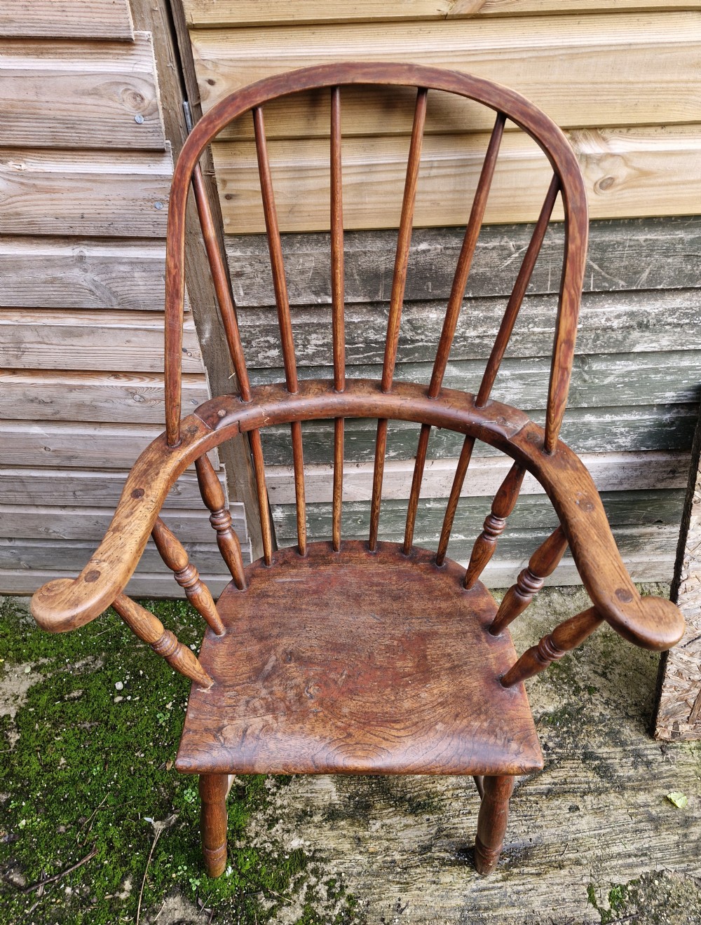 An early 19th-century West Country Windsor armchair with a high hoop back, turned wooden spindles, curved armrests, and a contoured saddle seat. View IV