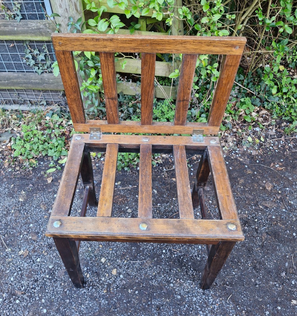 Luggage stand with fold up back .